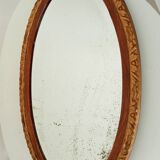 Antique oval mirror with beveled glass in wood and stucco, 19th century