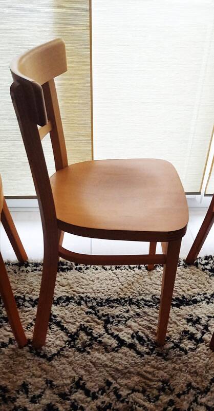 Set of 4 light wood bistro chairs stamped Baumann and Thonet.