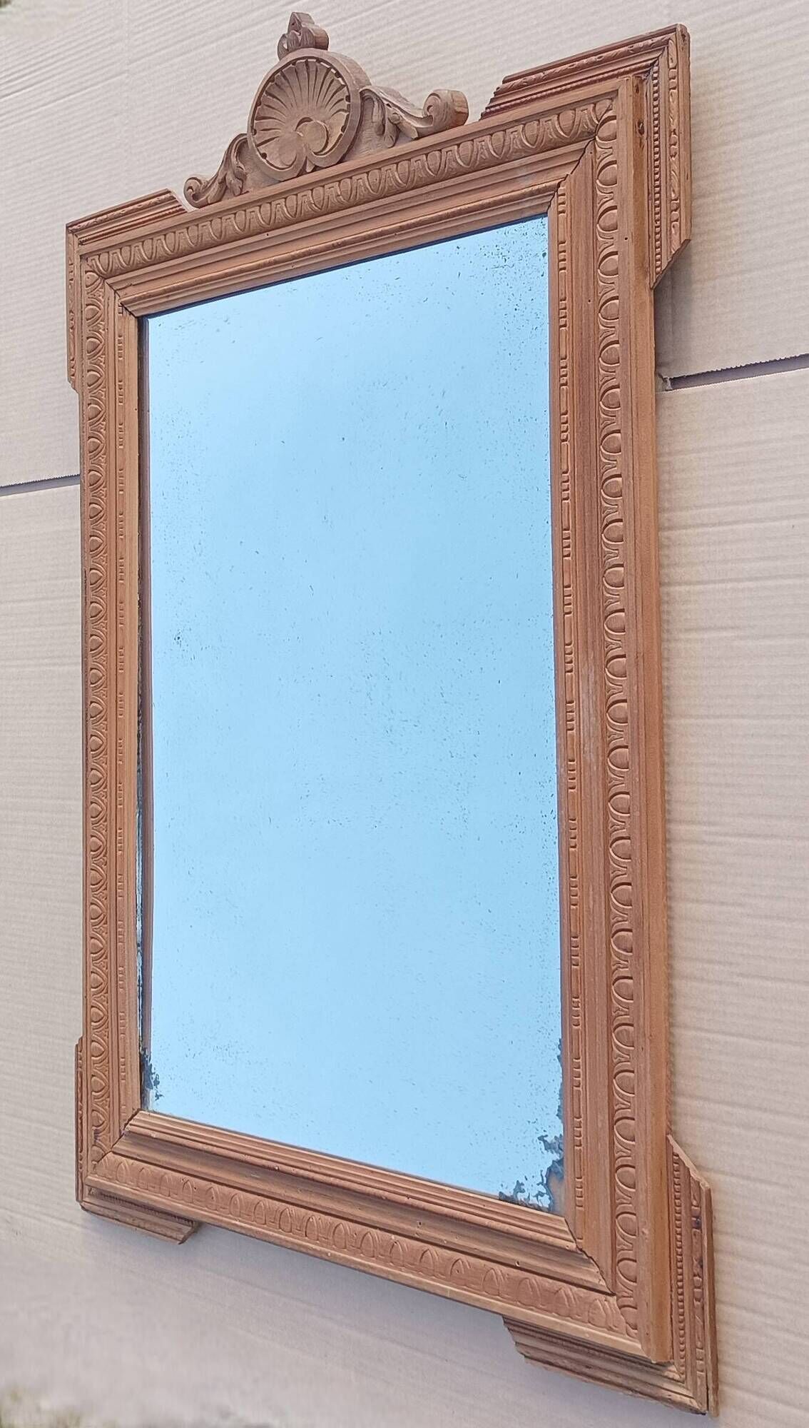 Louis XVI mirror in carved wood, 19th century.