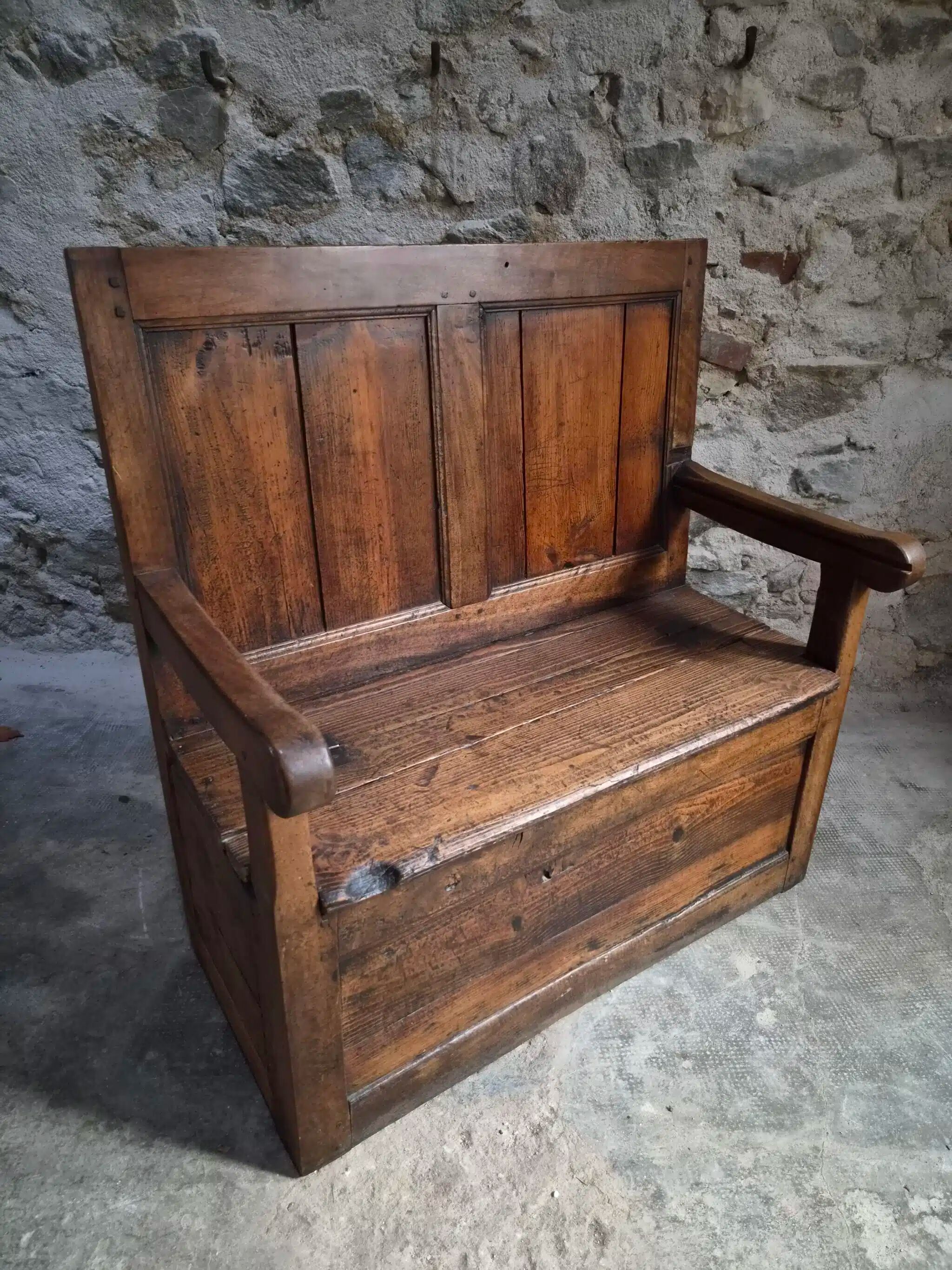 Rustic French antique storage bench from the 18th century in walnut and pine.
