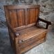Rustic French antique storage bench from the 18th century in walnut and pine.