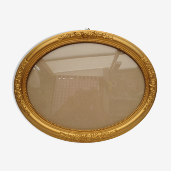 Large old oval gilded wooden frame and stucco decorations