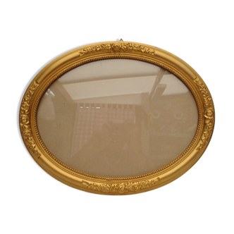Large old oval gilded wooden frame and stucco decorations