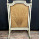 Front of Louis XVI fireplace in laqué wood and fabric has floral decorations