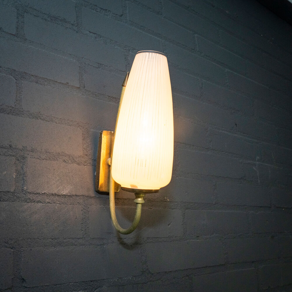 Ornate wall lamp made of milk glass and brass