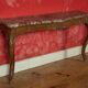 Important console in natural wood, moulded and carved with a red marble top.