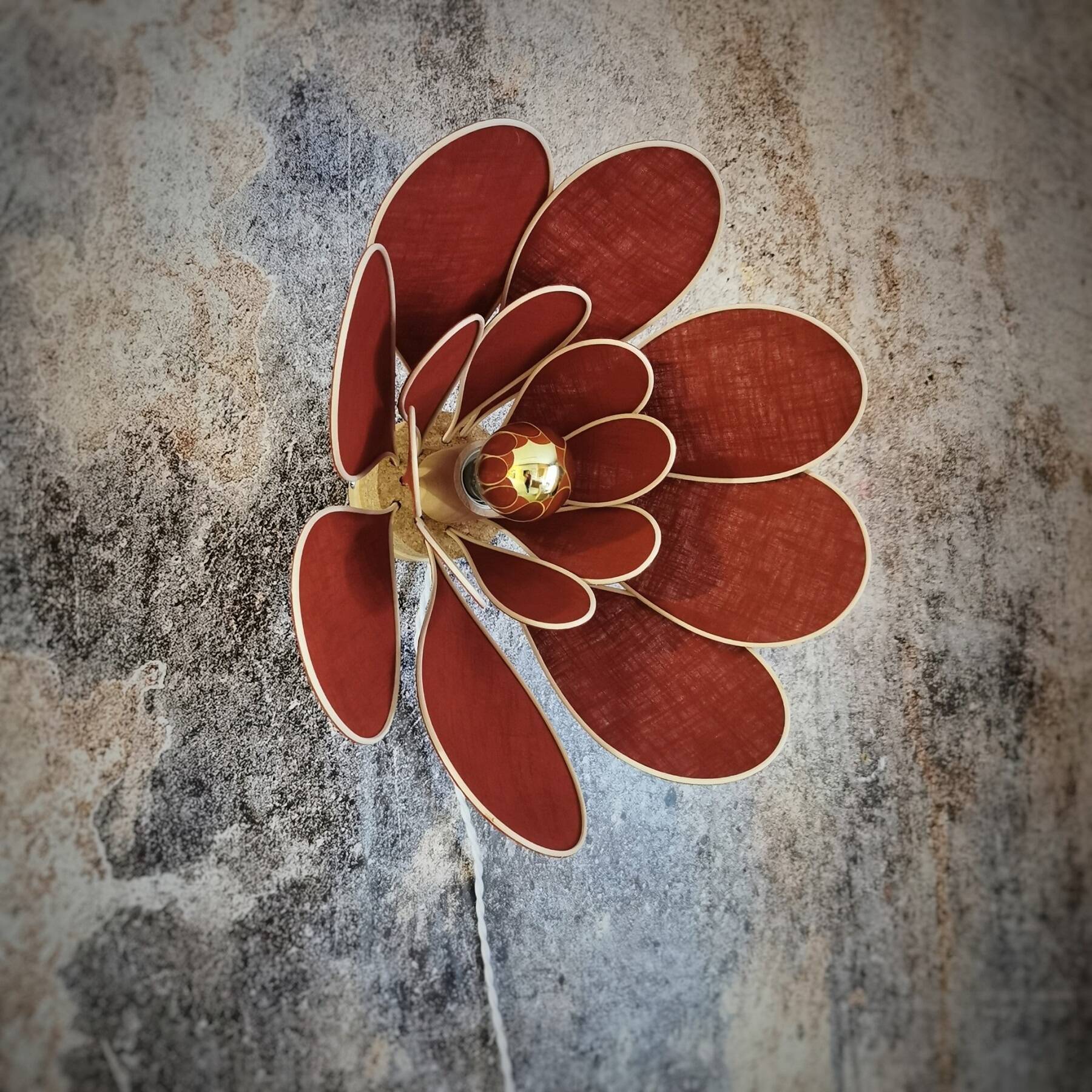Flower wall light made of rattan and terracotta linen petals
