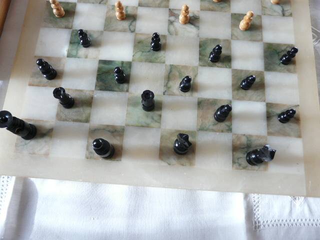 Onyx chessboard and complete wooden chess set.