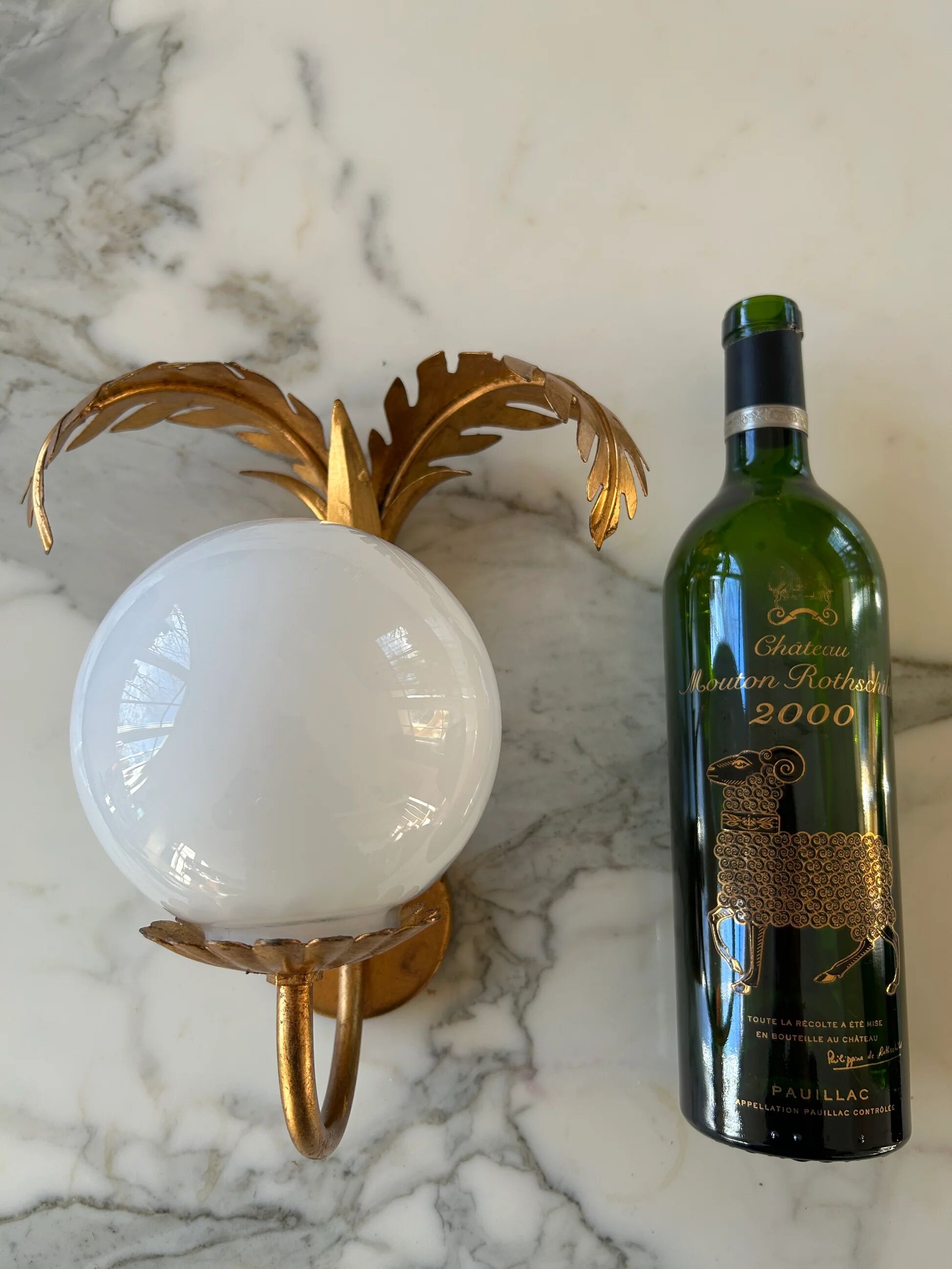 Pair of palm leaf wall lights in Hollywood Regency style with opaque globes by Hans Kögl, Germany, 1970s.