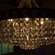 Antique castle style chandelier with tassels and floral details