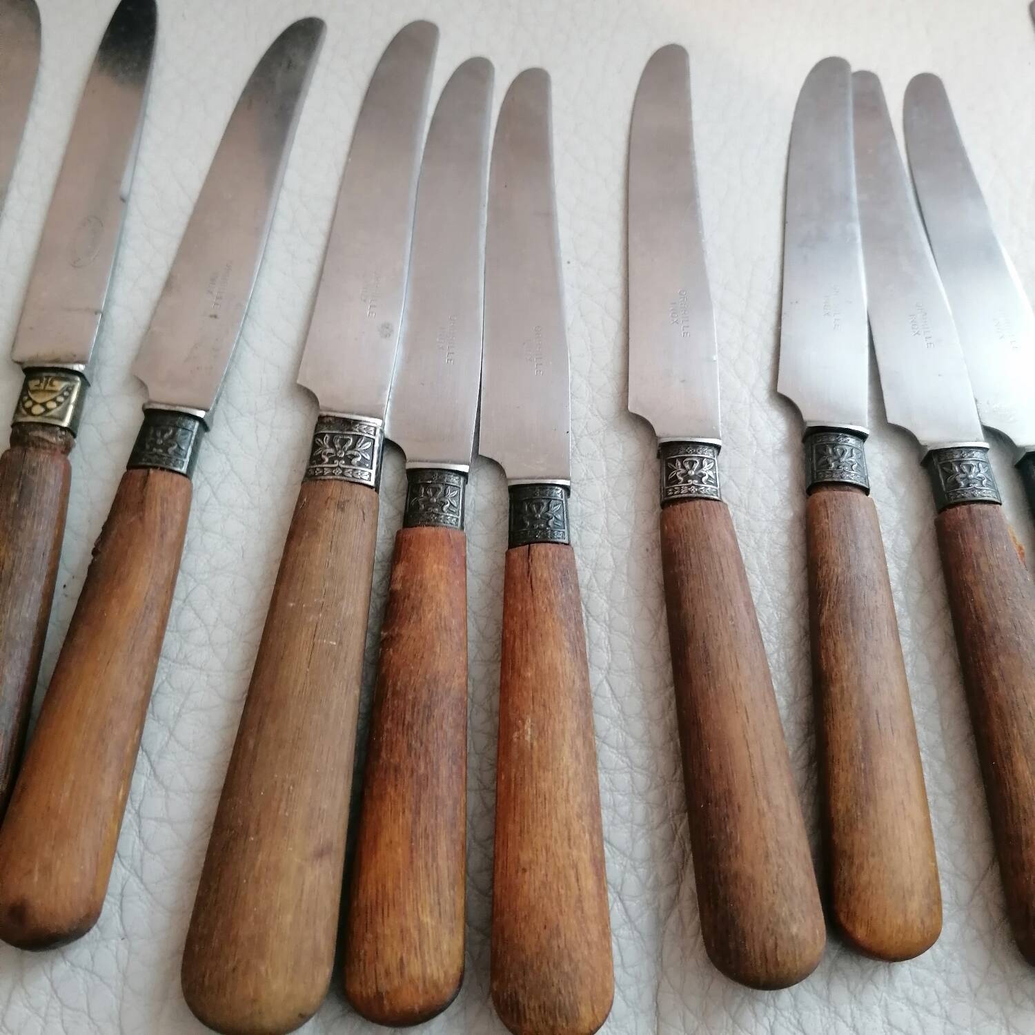 Old table knives and dessert knives, wooden handles, stainless steel blades
