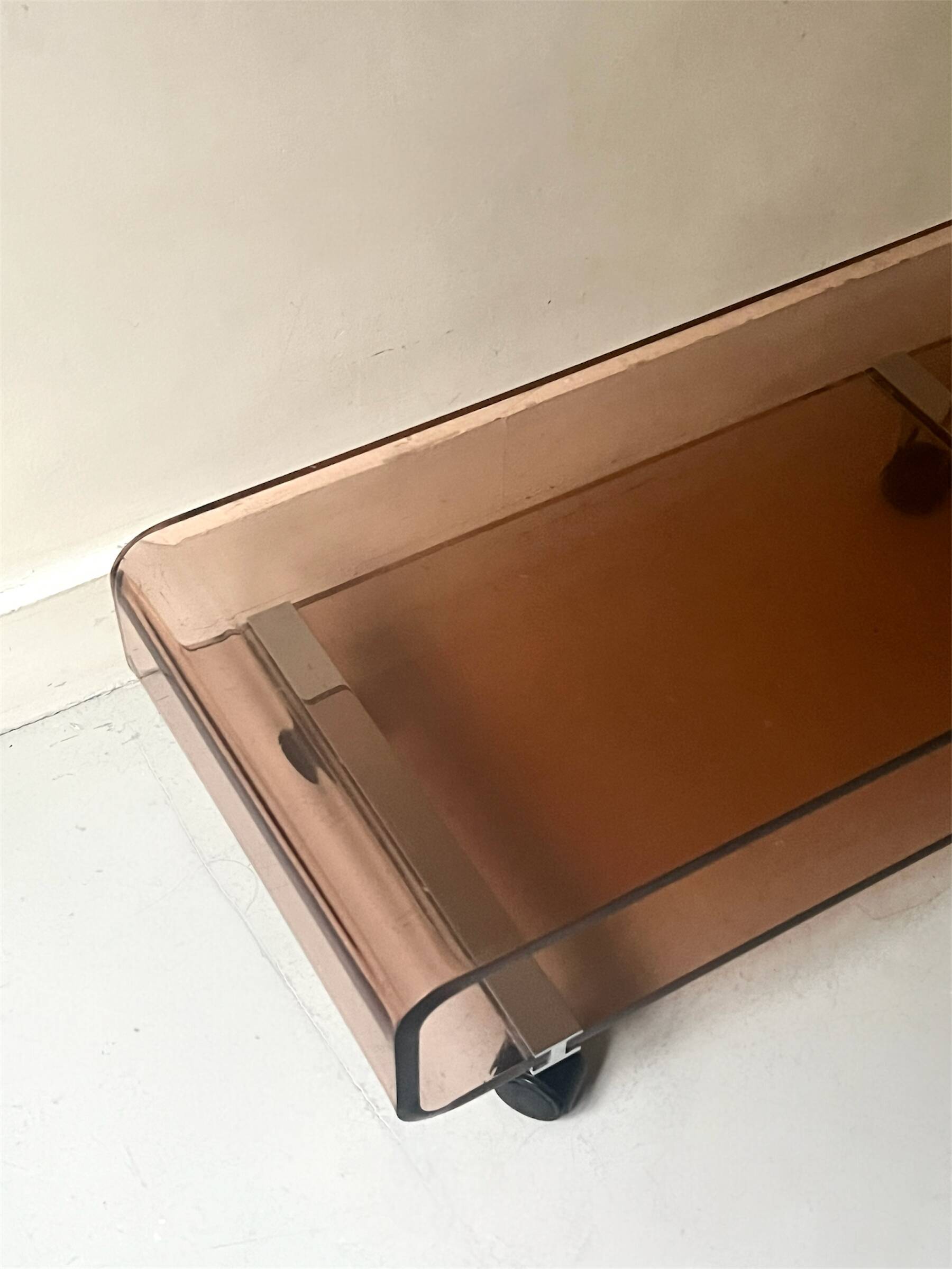 Smoked plexiglass coffee table on wheels, Roche Bobois design 1970.