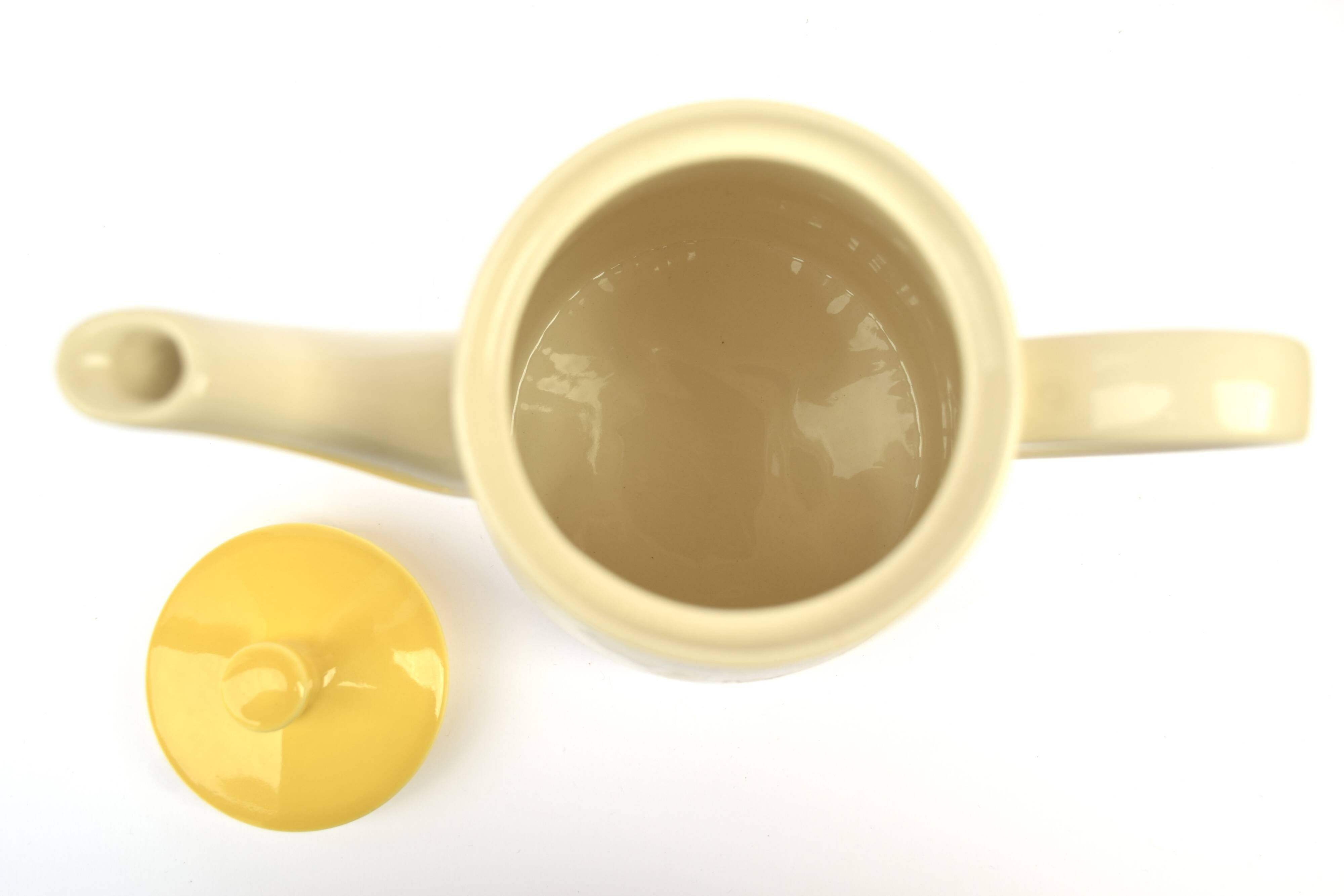 Old glazed ceramic coffee pot decorated with sunflowers