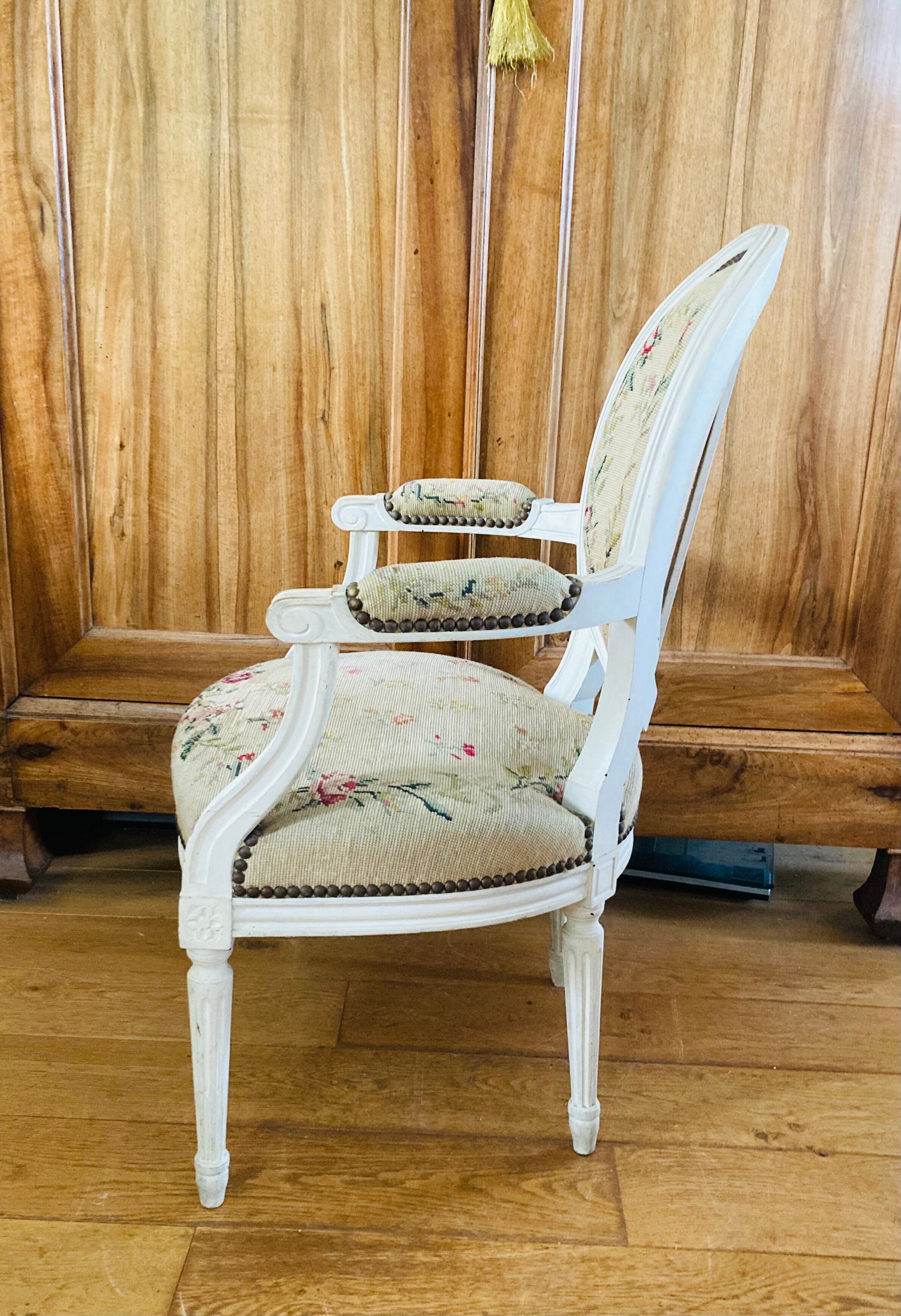Upholstered armchair with cross-stitch in the Louis XVI style, 19th century.