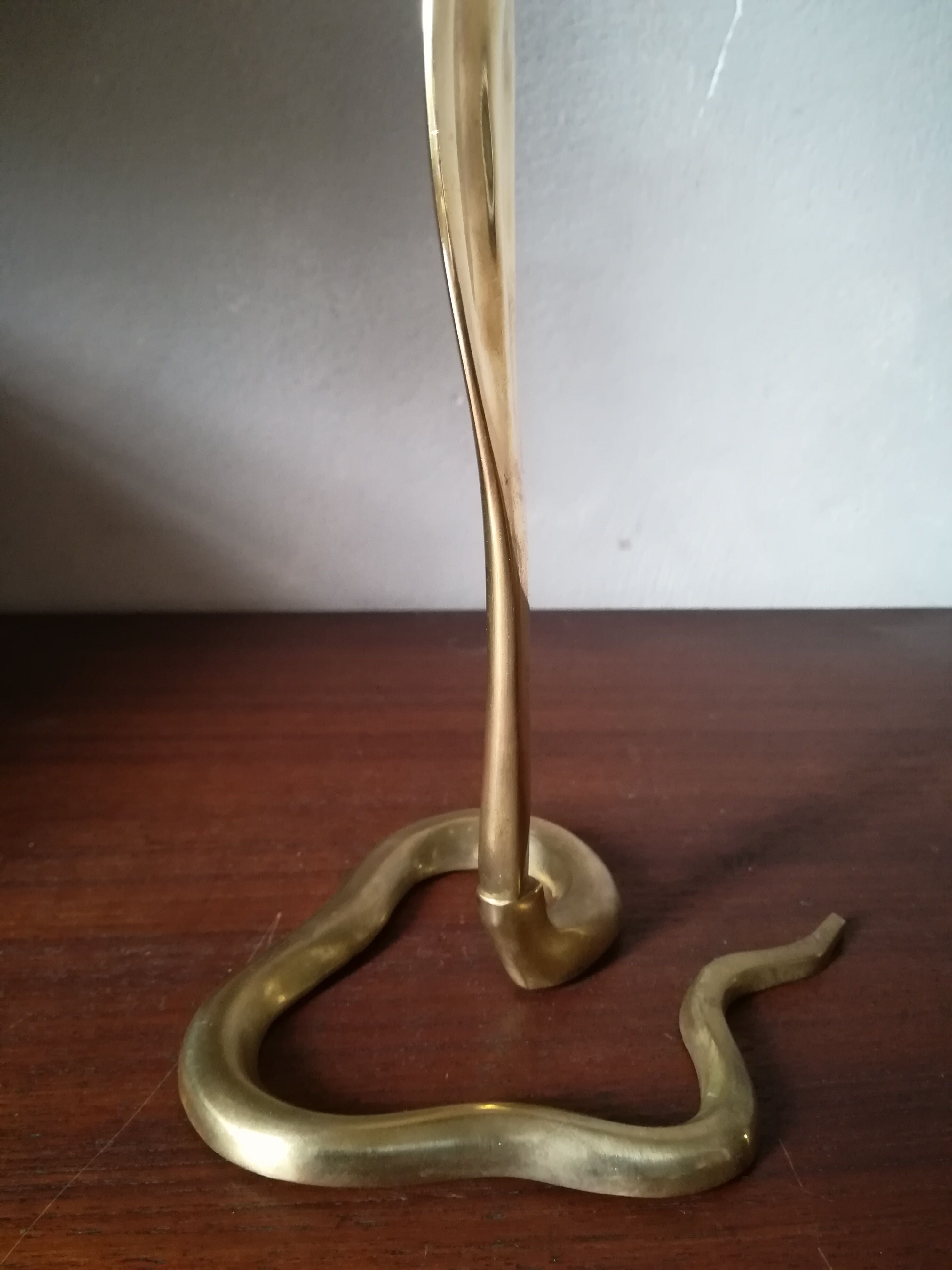 Candlestick mounted on brass cobra
