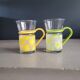Pair of glass teacups with plastic handles