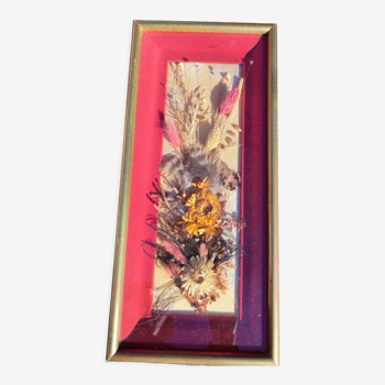 Frame containing dried flowers