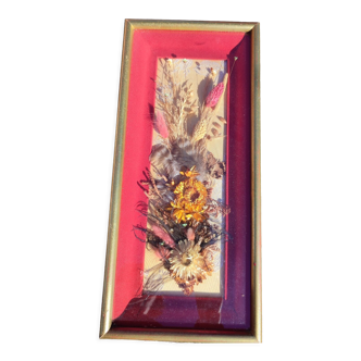 Frame containing dried flowers