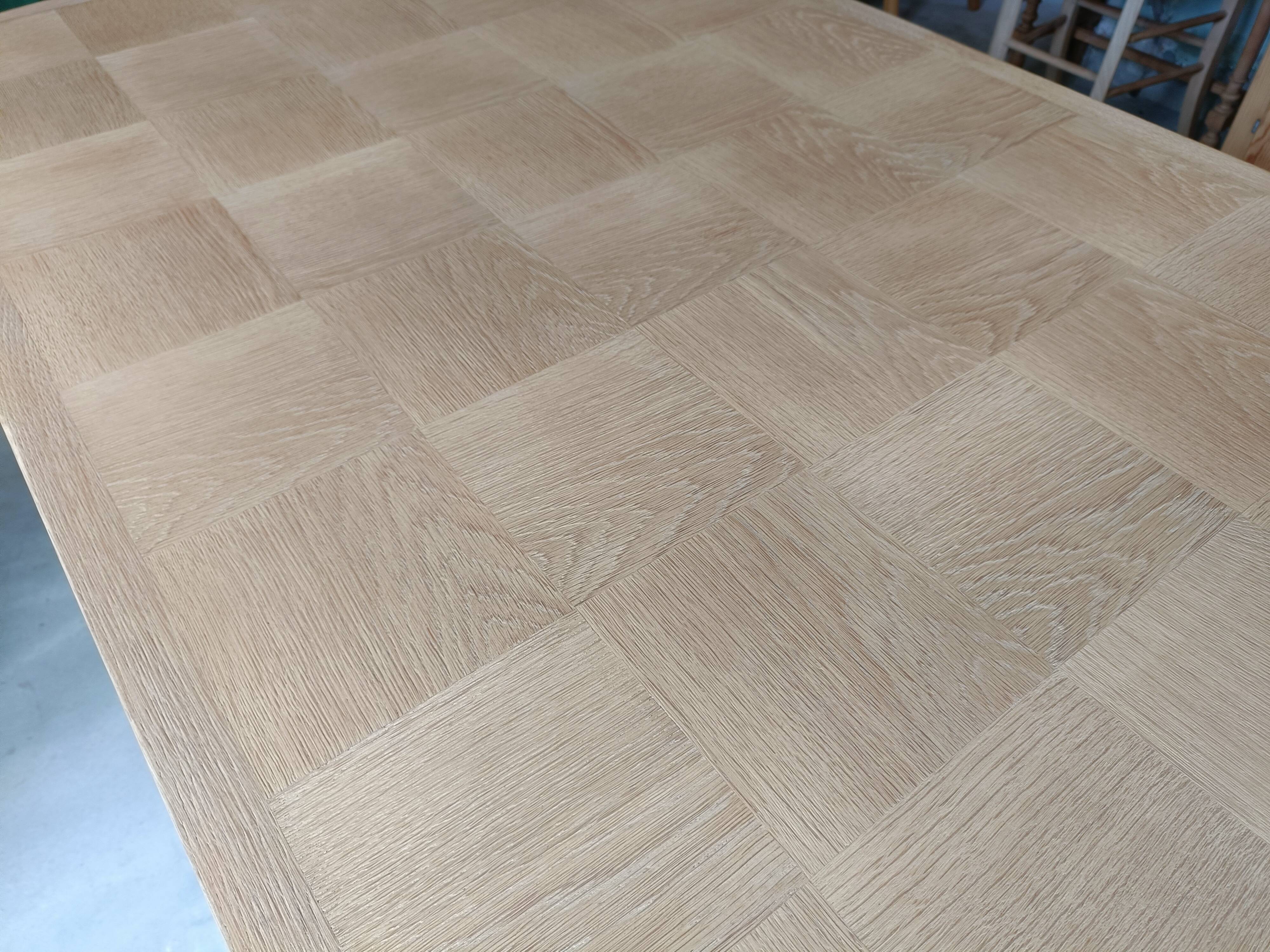 Oak dining table with a checkerboard top and extensions.
