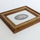 Vintage floral print with oval mat and gold wooden frame.