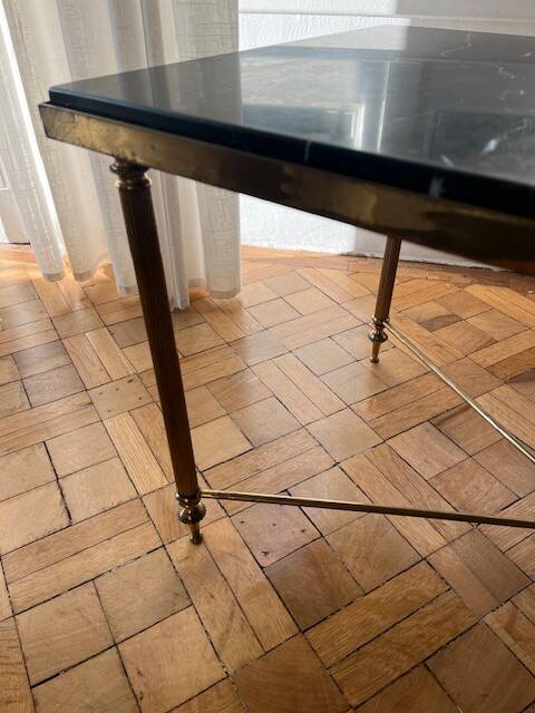 Black marble coffee table with brass legs.