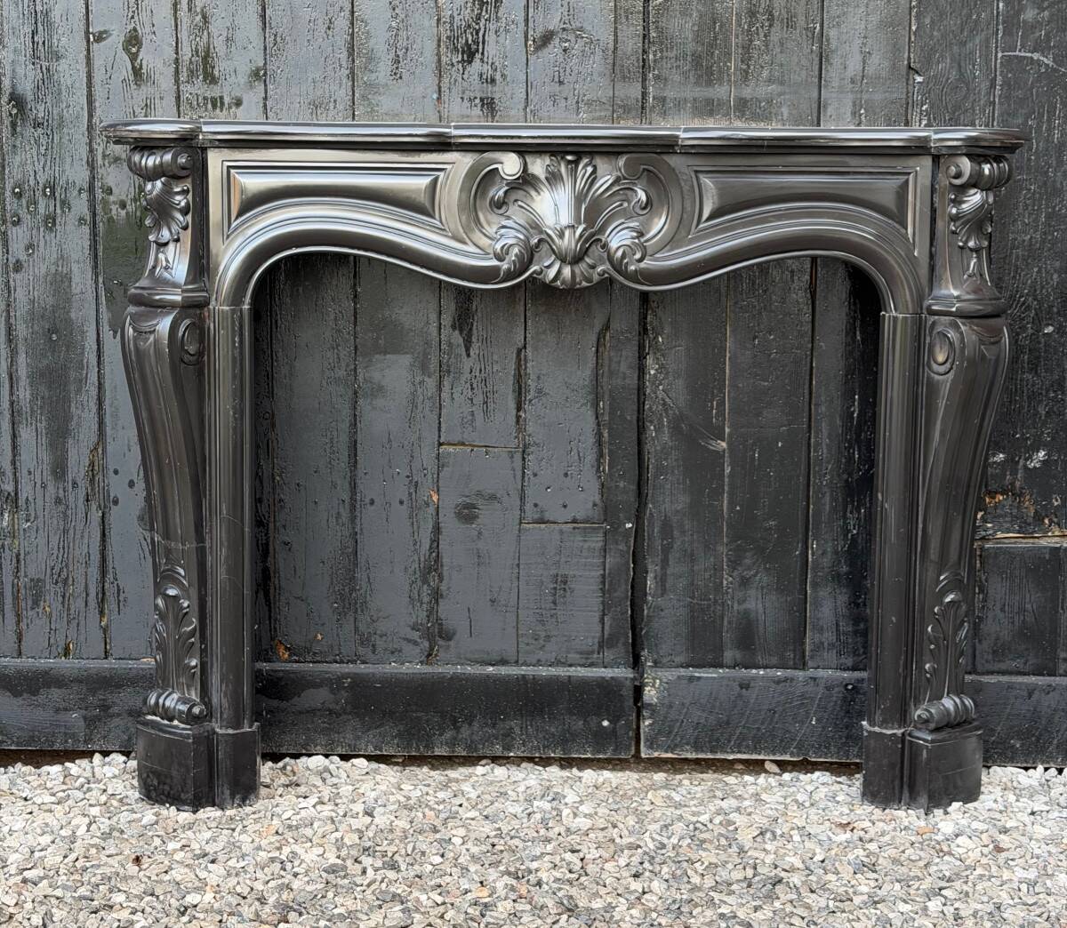 Louis XV style fireplace in black Belgian marble, circa 1880.