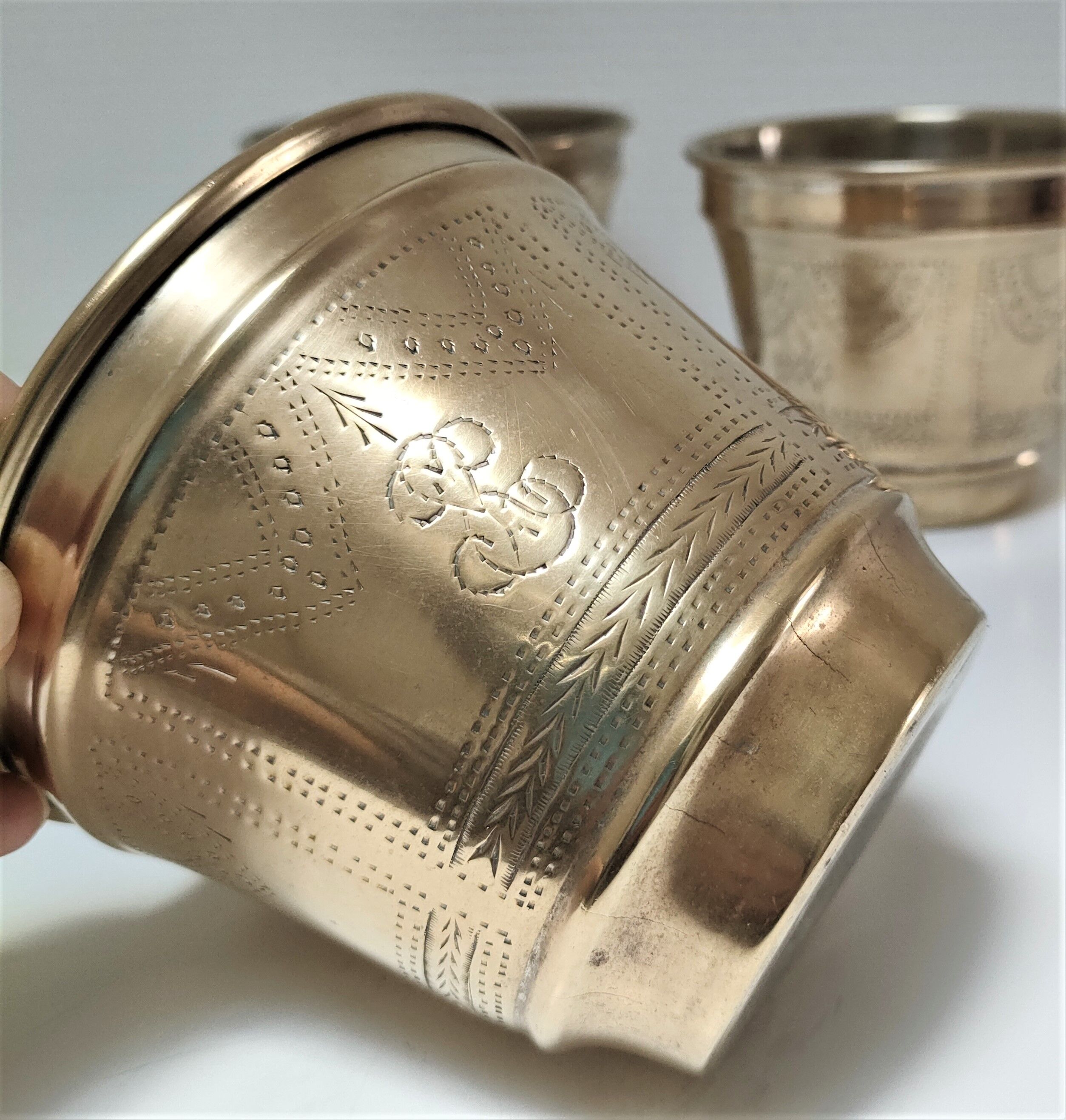 Three pot covers brass silver cover golden patina monogram early twentieth century