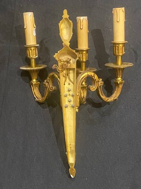 Pair of gilt bronze wall sconces with three lights in the Louis XVI style.