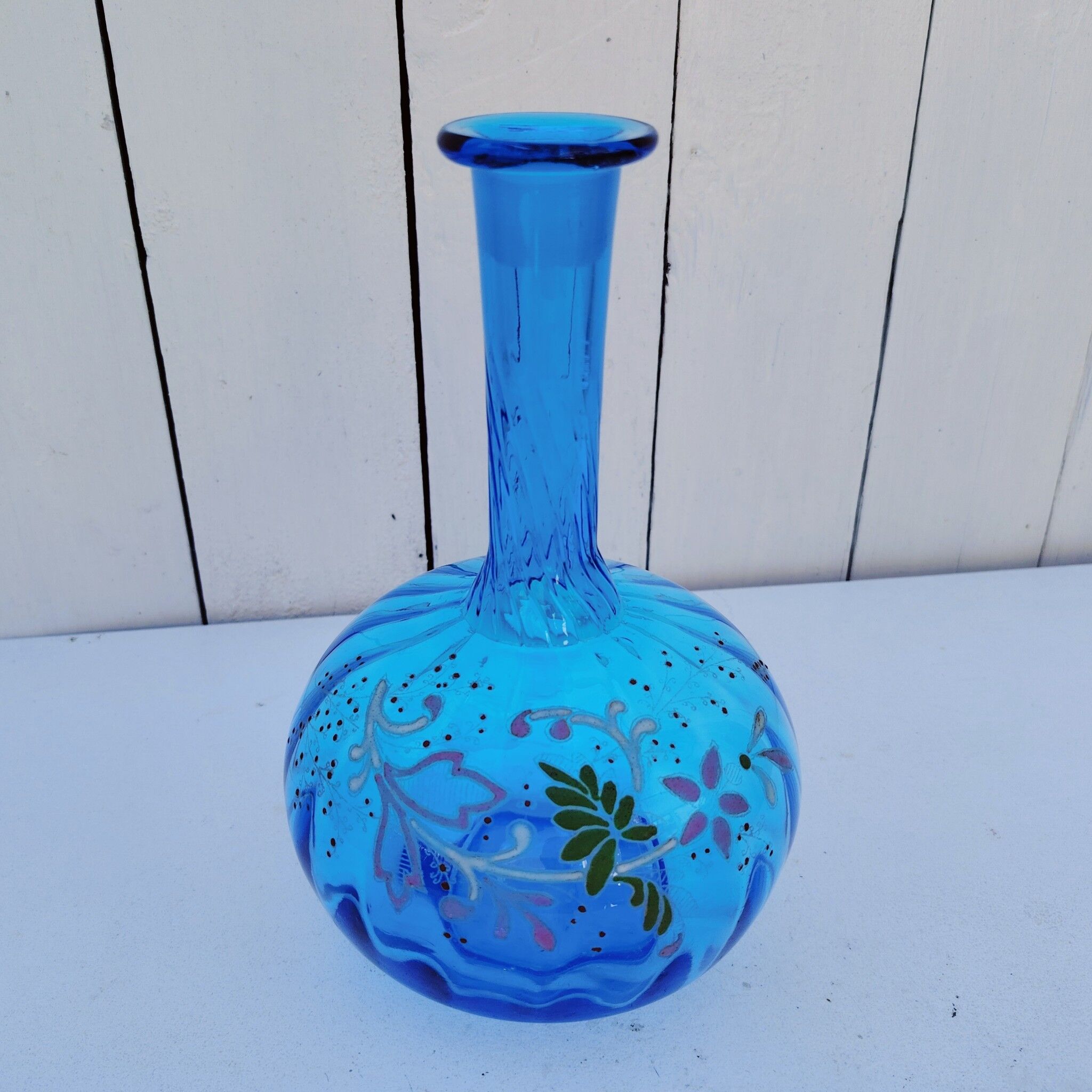 Vintage twisted blue glass carafe with enamel decoration.