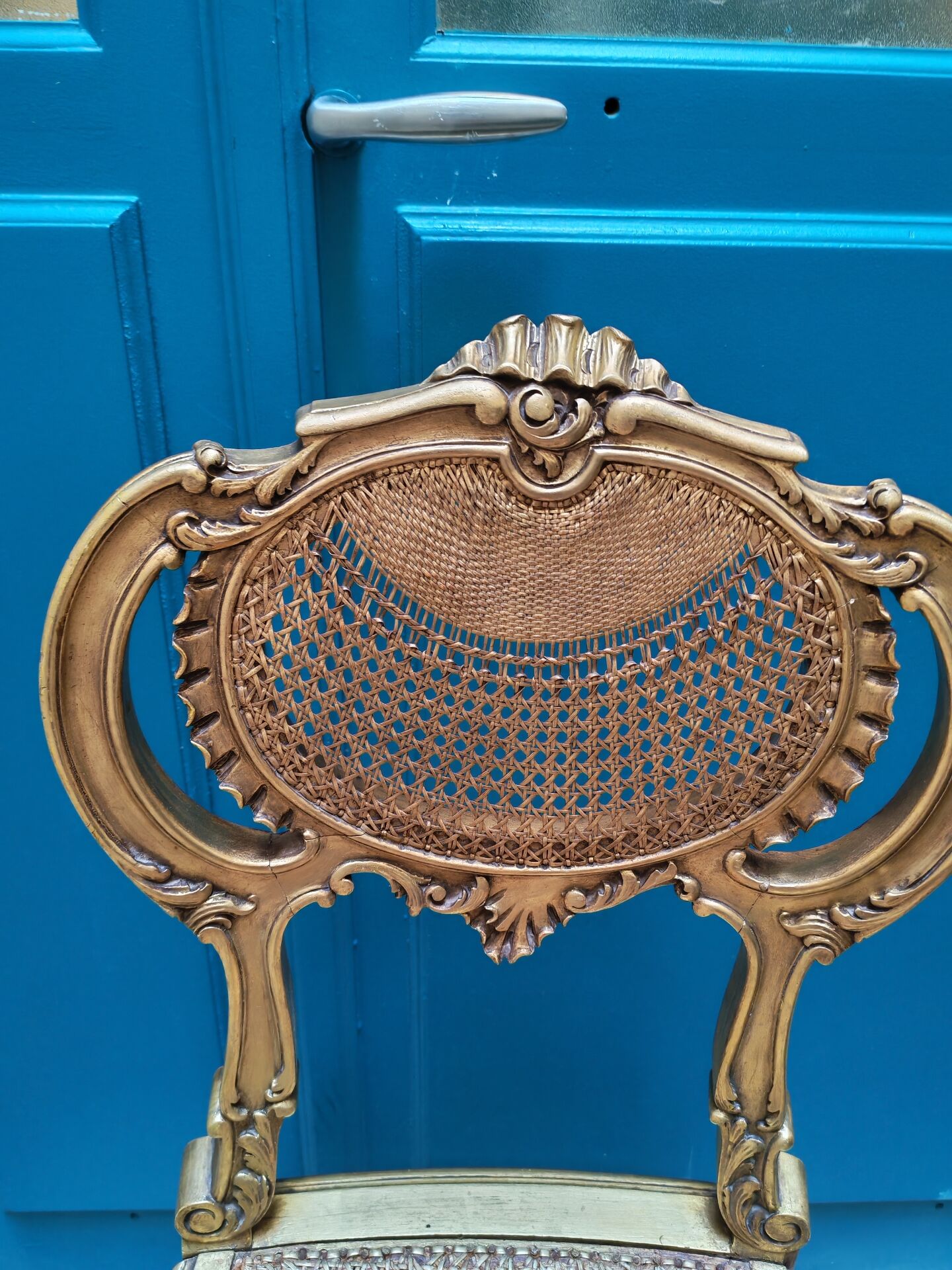 Antique rococo chair in gilded wood and caning
