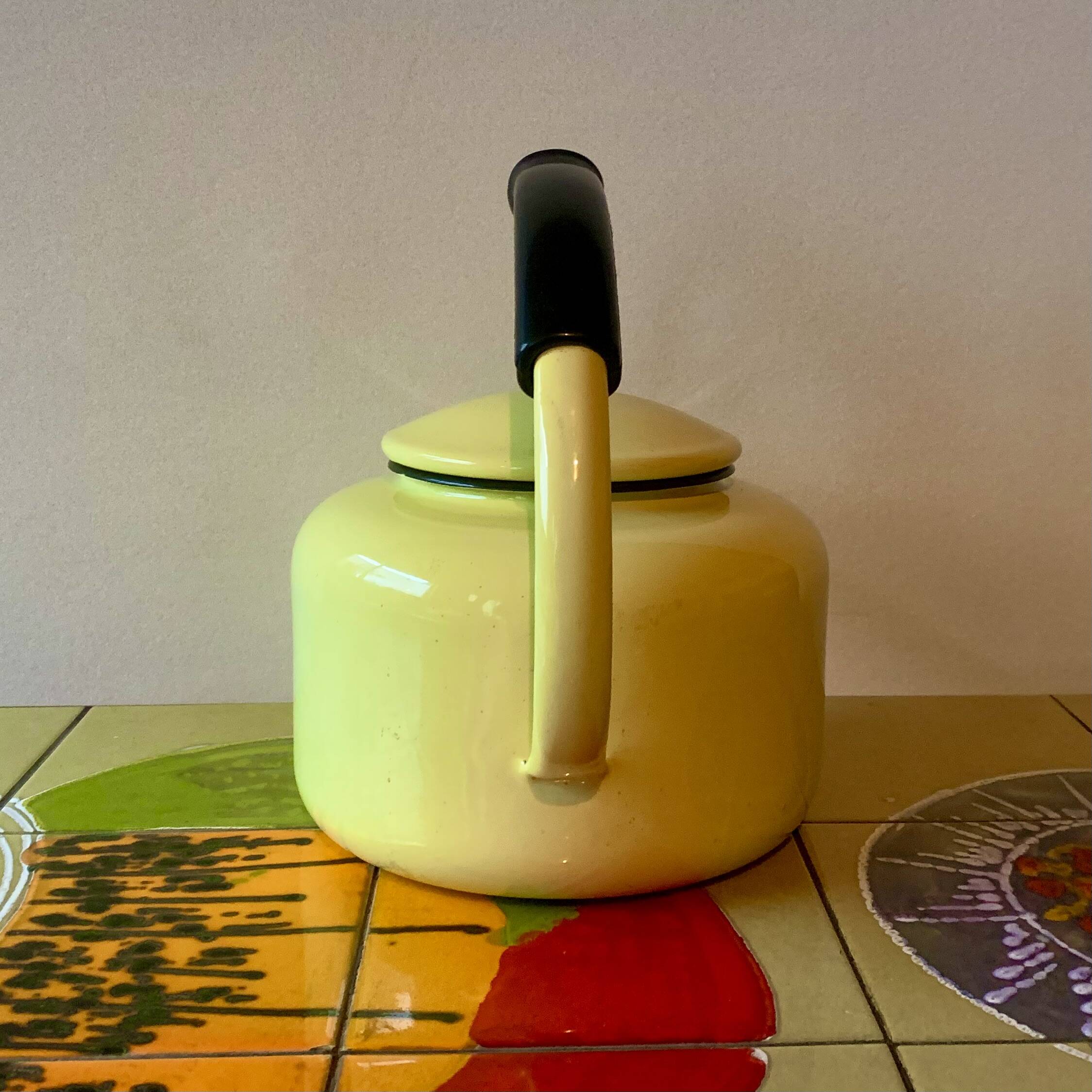 Old kettle in yellow enamelled sheet metal and Bakelite