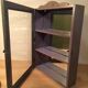 Display shelf with miniature blue wood and mirrors