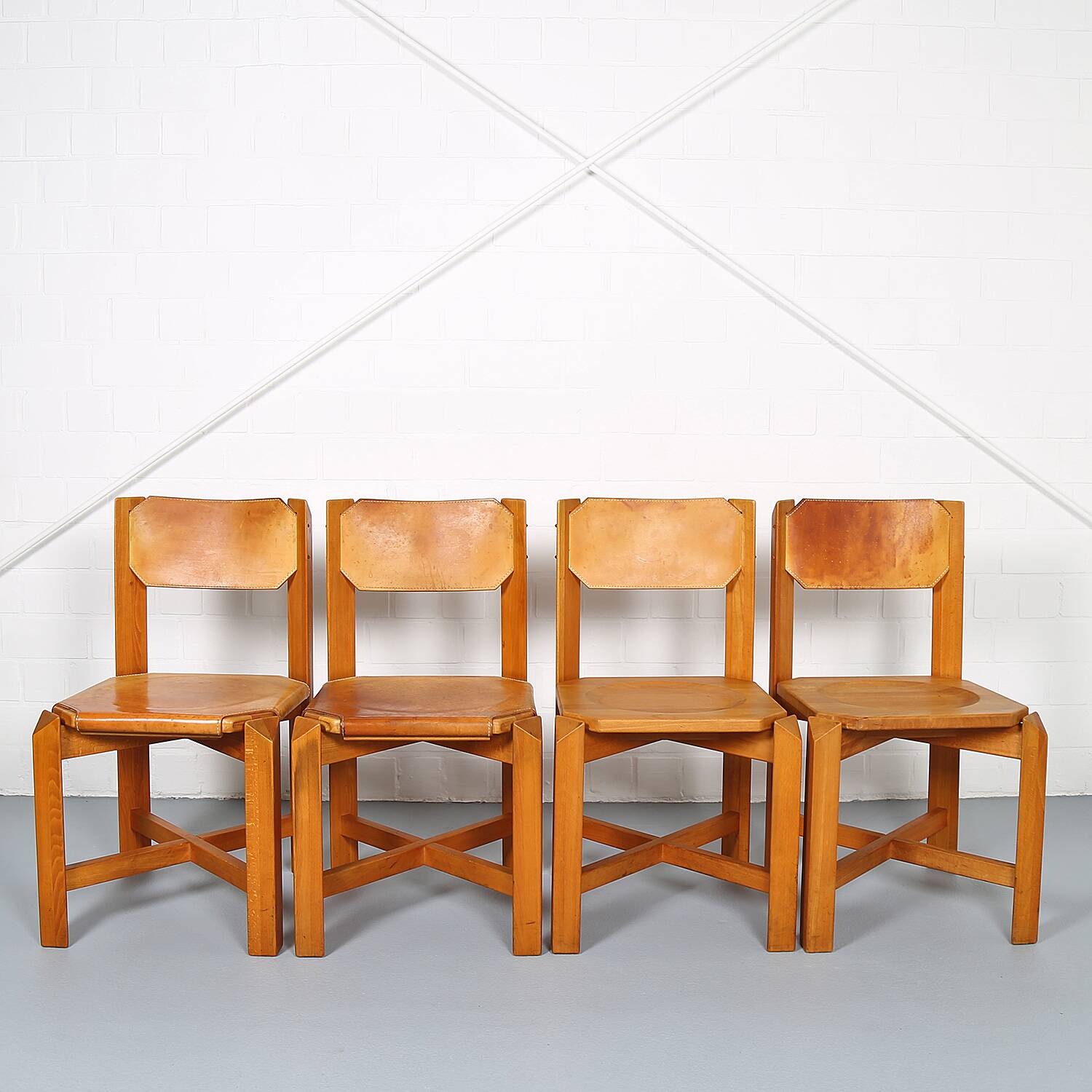 Set of 4 dining chairs in elm wood and cognac leather.