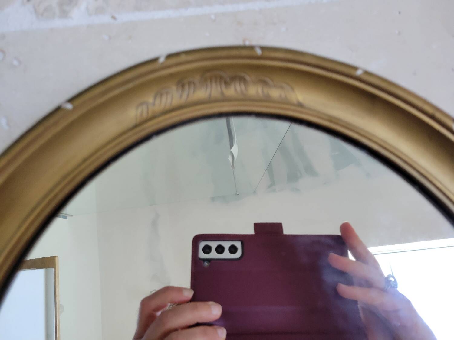Oval mirror in gilded stucco 45 cm