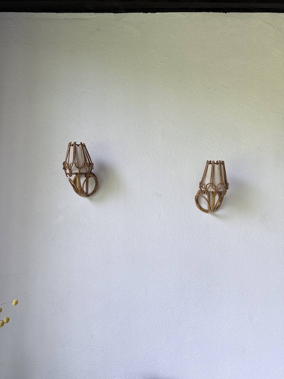 Pair of rattan wall lights by Louis Sognot, 1960.