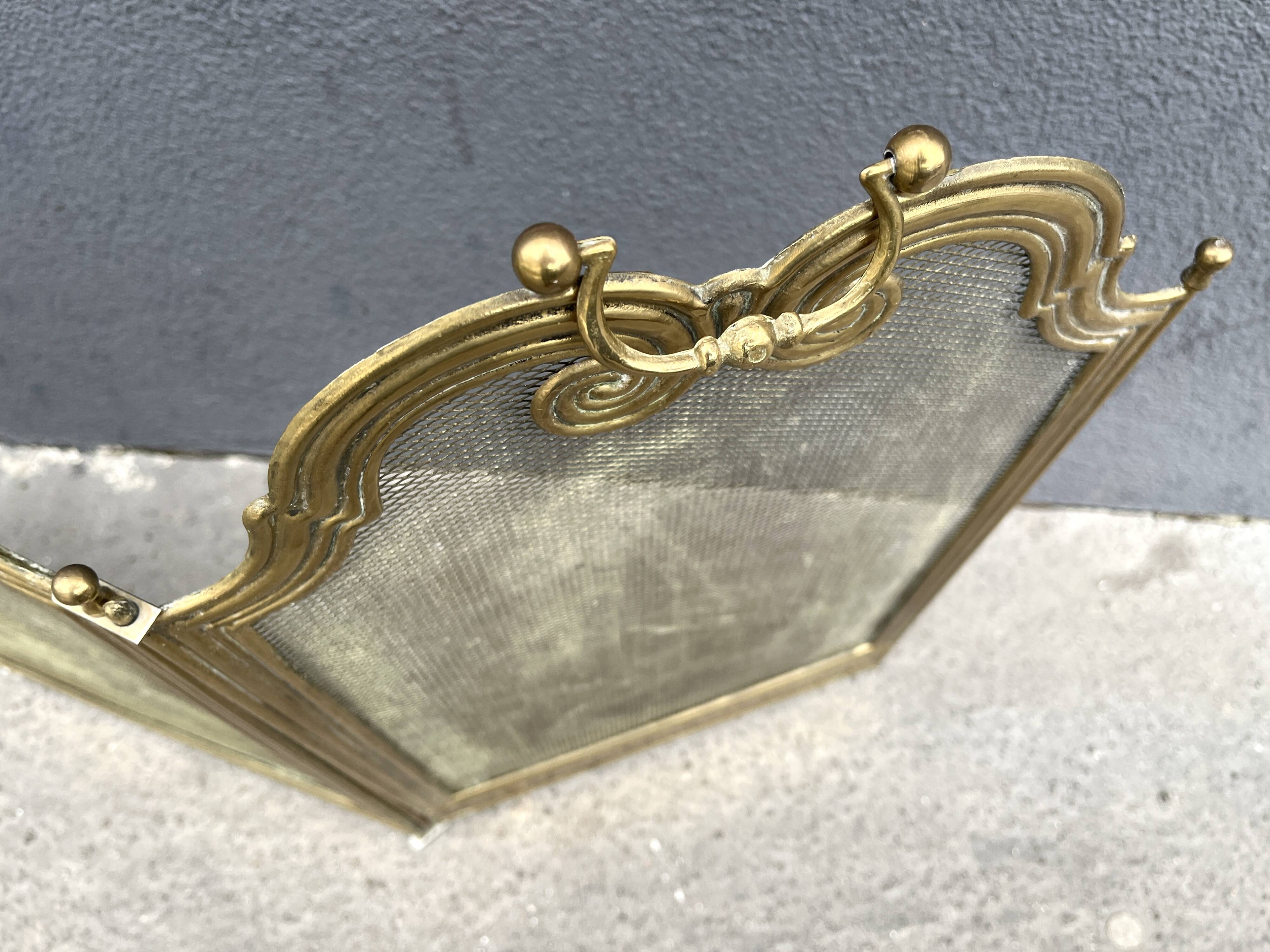 Antique brass fireplace screen from 1920, vintage spark guard.