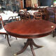 Round extendable dining table for six people, mahogany.