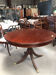 Round extendable dining table in mahogany.