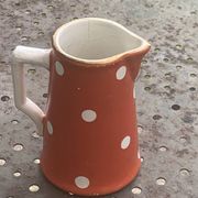 Milk jug, pitcher with white polka dots on orange earthenware, Sarreguemines and Digoin