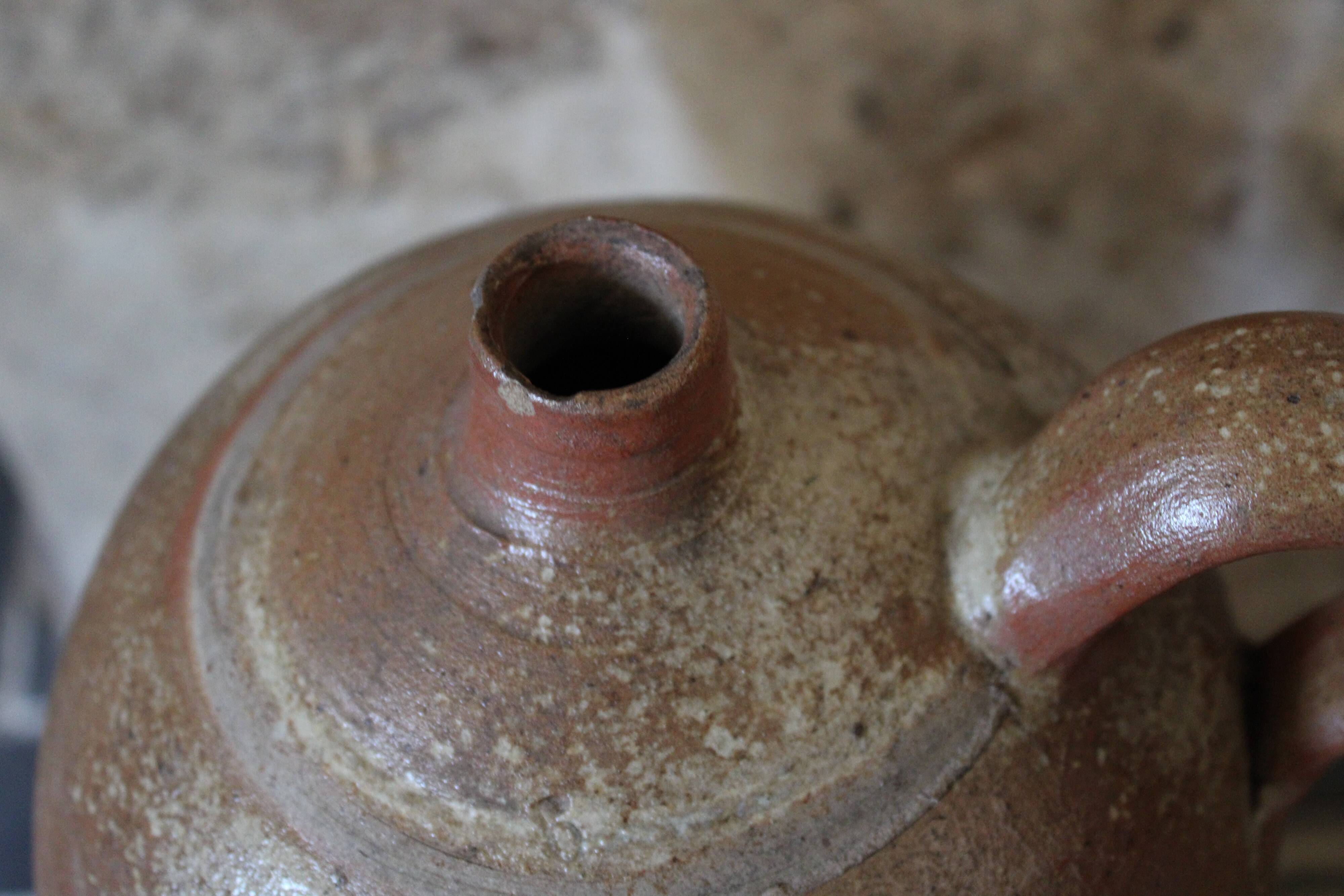 Vernified sandstone oil jar with handle