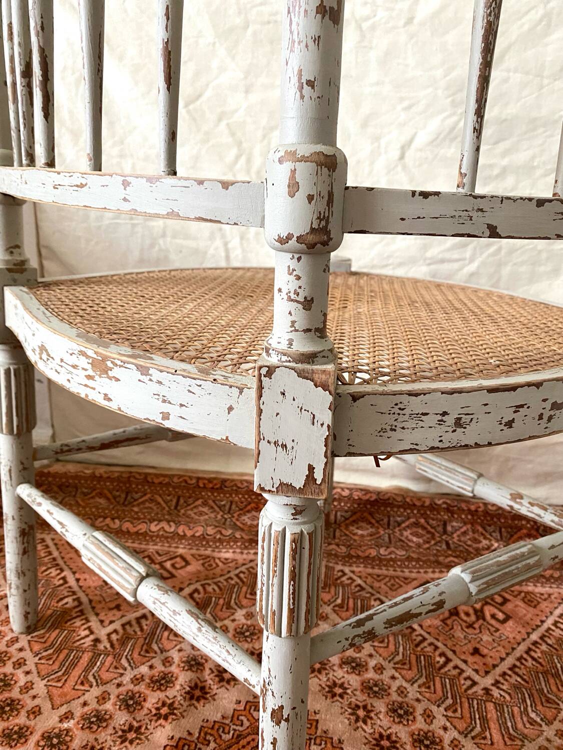 19th-century corner fireplace armchair, wood and cane.