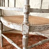 19th-century corner fireplace armchair, wood and cane.