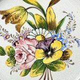Decorative earthenware and pewter wall plate with spring flowers