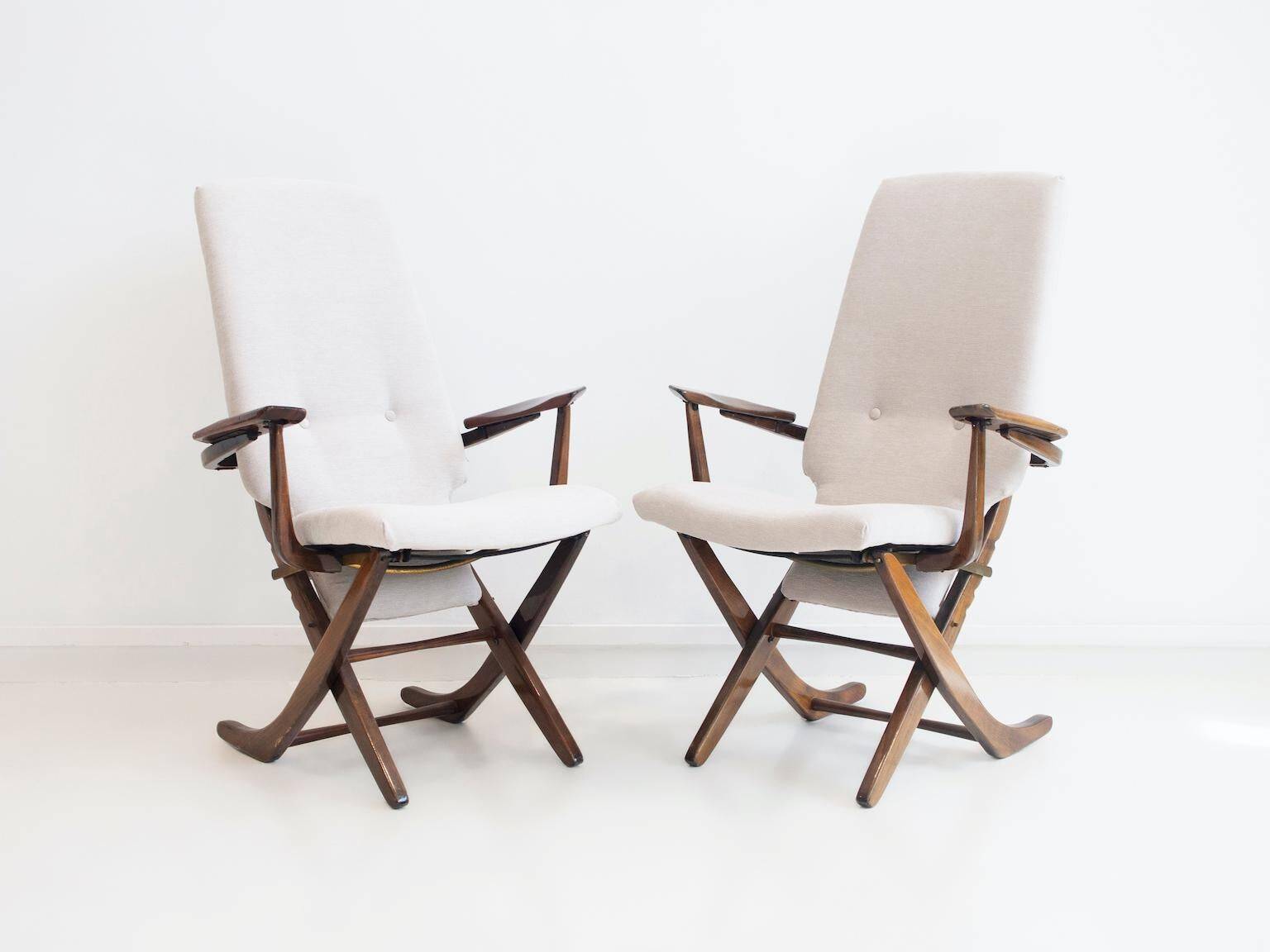 Pair of varnished wooden reclining armchairs, upholstered in lightweight fabric.