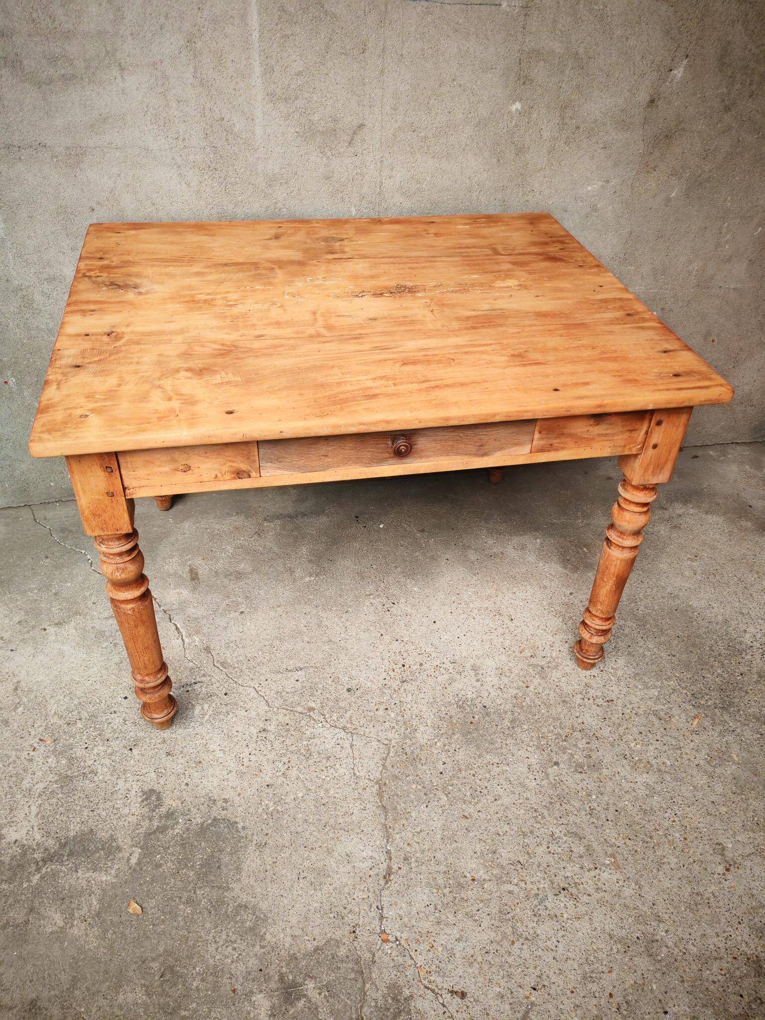 Small farmhouse table in light wood and tiled floors
