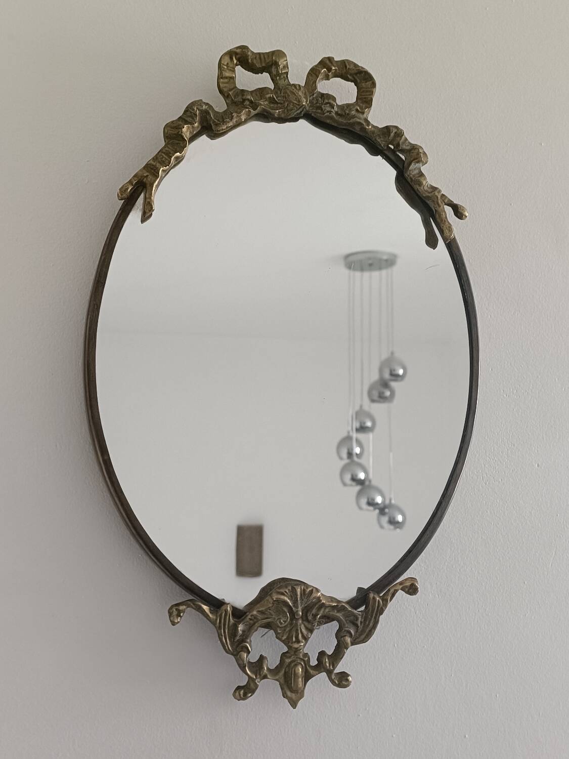 Antique mirror, oval with brass crest