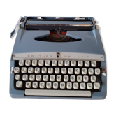 Vintage Brother de Luxe typewriter and its cover