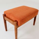 Vintage armchair and footrest in orange corduroy.