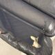 Vintage black leather lounge chair — low postmodern club chair from the space age.