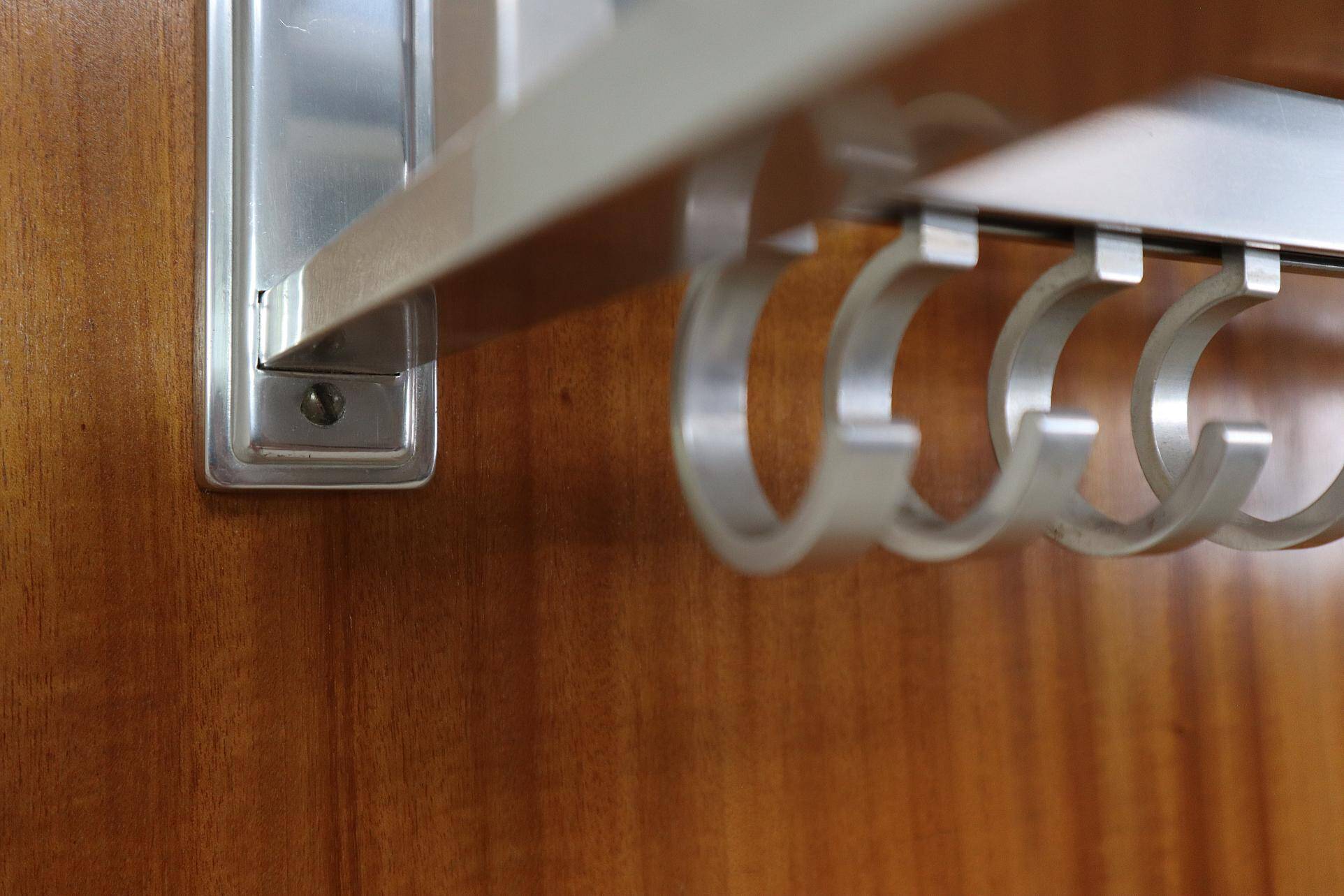 Modernist wall-mounted cloakroom in teak